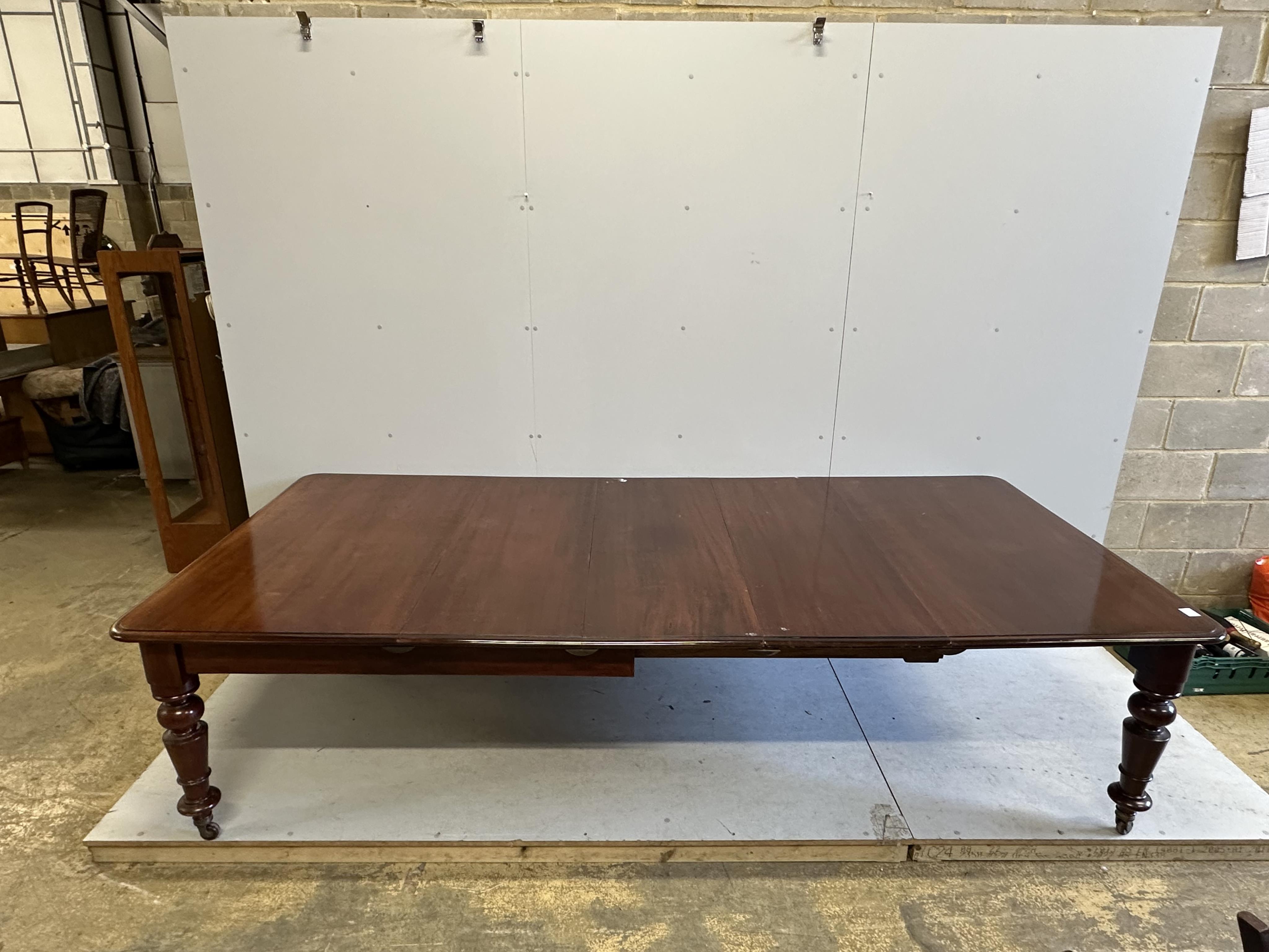 A Victorian rectangular mahogany extending dining table, 280cm extended, three spare leaves, depth 130cm, height 74cm. Condition - fair to good